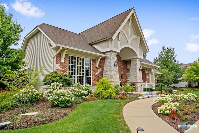 1683 Briarheath Dr, Aurora, IL 60505 - tudor house with brick siding, a shingled roof, and a front yard