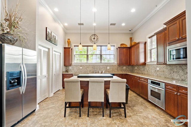 1683 Briarheath Dr, Aurora, IL 60505 - kitchen featuring a breakfast bar area, a kitchen island, crown molding, appliances with stainless steel finishes, and tasteful backsplash