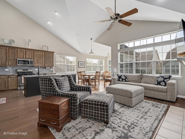 1683 Briarheath Dr, Aurora, IL 60505 - living room with high vaulted ceiling, a ceiling fan, and wood finished floors