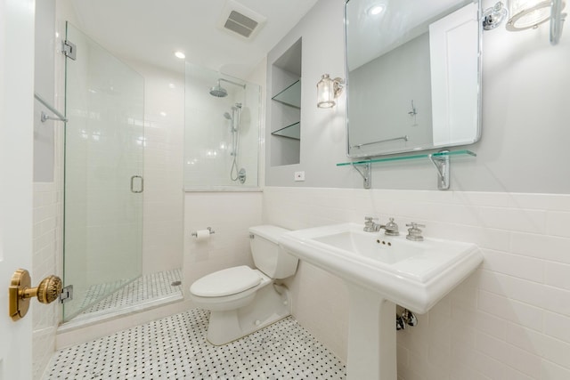 full bath featuring tile walls, visible vents, a shower stall, and toilet