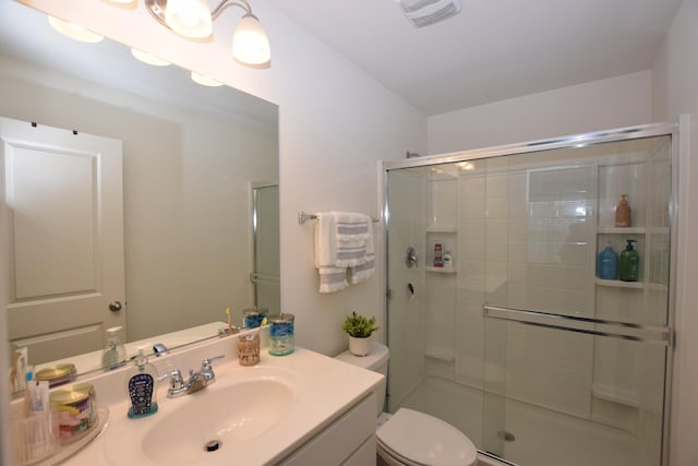 full bathroom featuring a shower stall, visible vents, toilet, and vanity