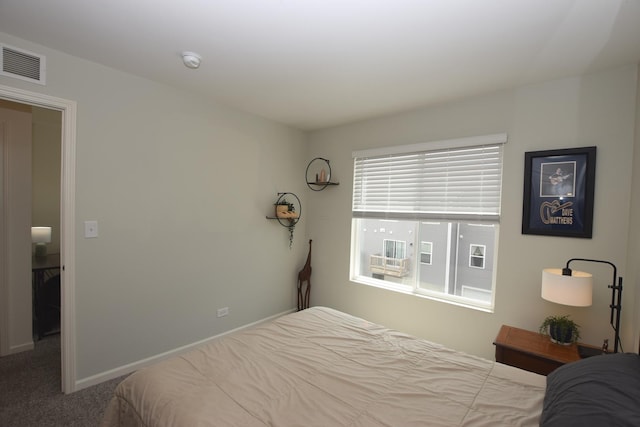 bedroom with baseboards, carpet flooring, and visible vents