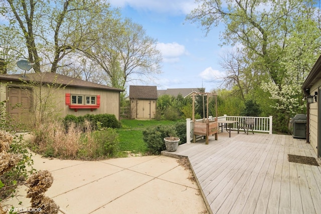 wooden deck with a storage unit and an outbuilding