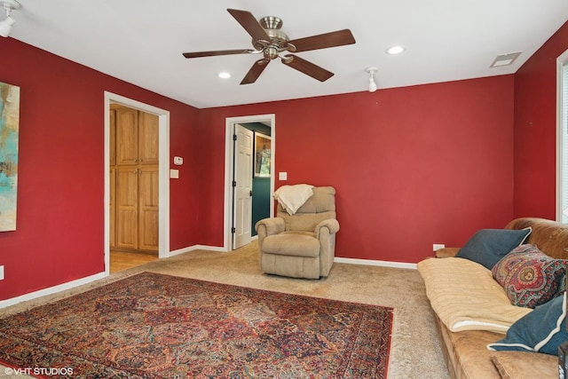 carpeted living area with baseboards, ceiling fan, recessed lighting, and visible vents