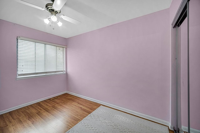 791 Overland Ct, Roselle, IL 60172 - unfurnished bedroom featuring baseboards, a ceiling fan, wood finished floors, and a closet