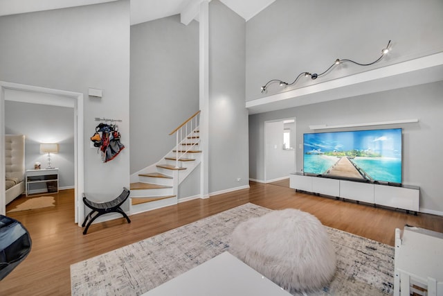 791 Overland Ct, Roselle, IL 60172 - living area with baseboards, wood finished floors, high vaulted ceiling, and stairway