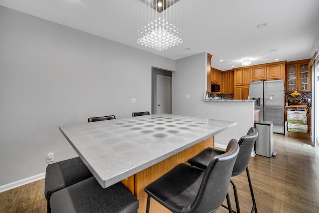 791 Overland Ct, Roselle, IL 60172 - kitchen featuring stainless steel fridge, wood finished floors, a notable chandelier, and brown cabinets
