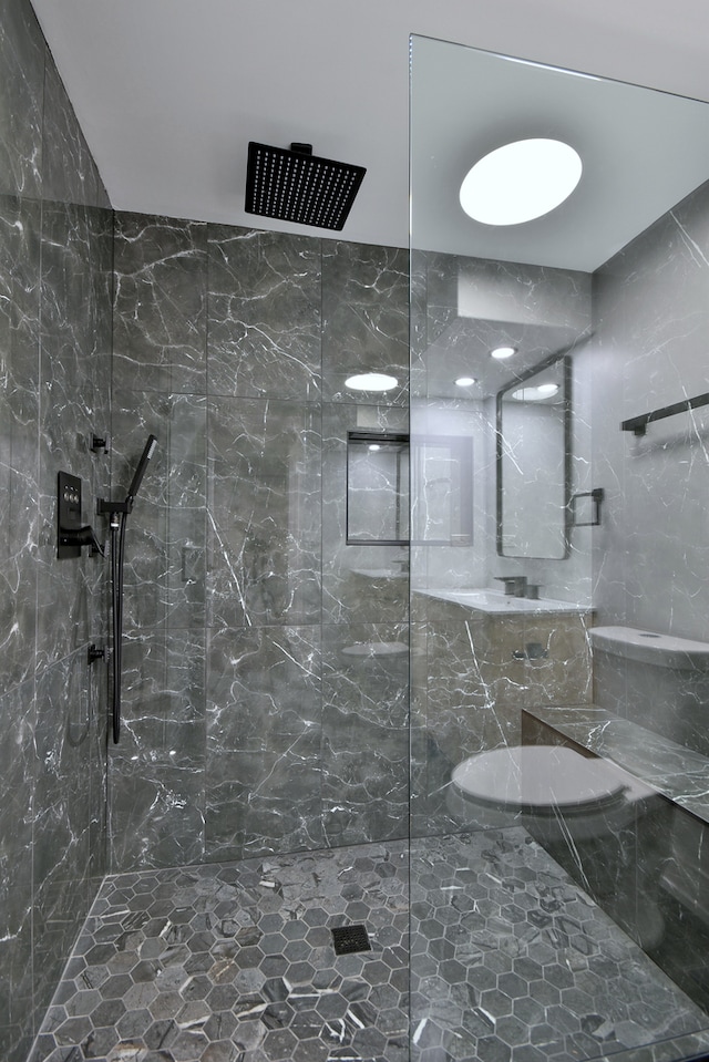 bathroom with a marble finish shower