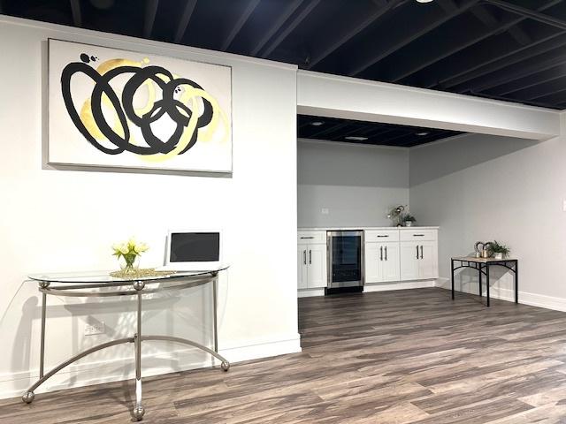 bar with dark wood finished floors, baseboards, and wine cooler