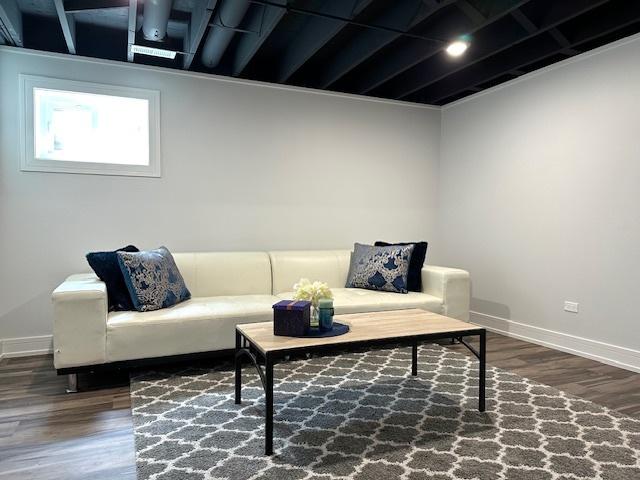 living room featuring baseboards and wood finished floors