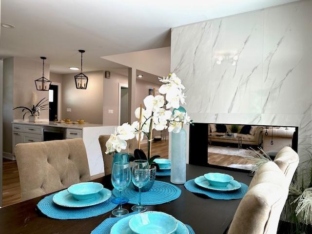 dining space with wood finished floors and recessed lighting