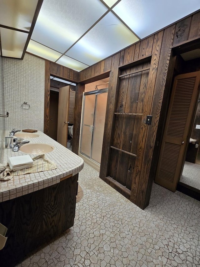 12211 S 93rd Ave, Palos Park, IL 60464 - full bath with a stall shower, wood walls, and double vanity