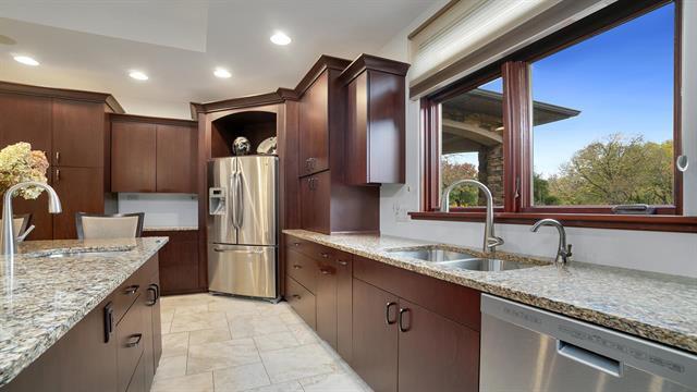 kitchen with light stone counters, a sink, recessed lighting, and appliances with stainless steel finishes