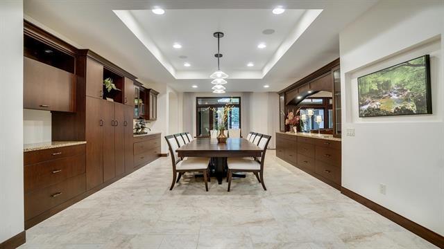 dining space with baseboards, marble finish floor, recessed lighting, and a raised ceiling
