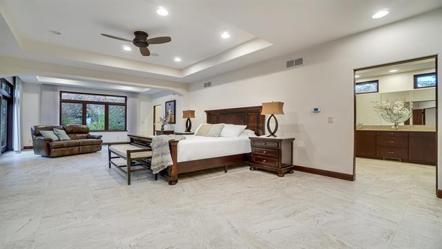 bedroom featuring baseboards, visible vents, recessed lighting, marble finish floor, and a raised ceiling