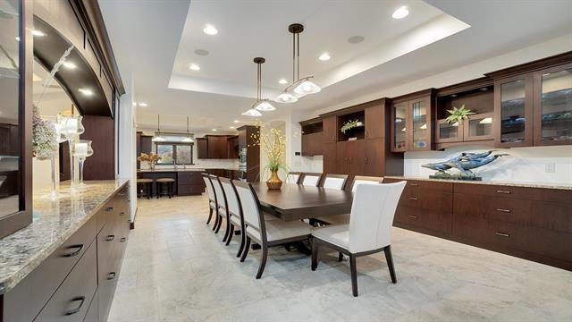 dining area with recessed lighting and a raised ceiling