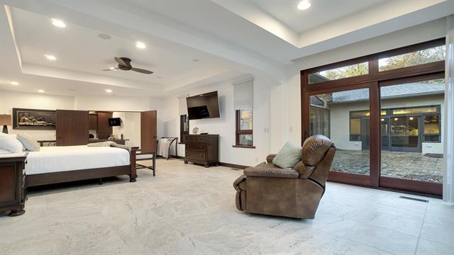 bedroom with marble finish floor, a raised ceiling, access to outside, visible vents, and recessed lighting