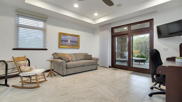 office with a raised ceiling, a ceiling fan, and recessed lighting