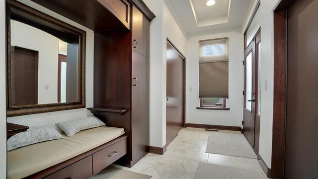 hall with a raised ceiling and baseboards