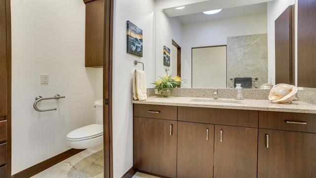 bathroom featuring toilet, vanity, and baseboards