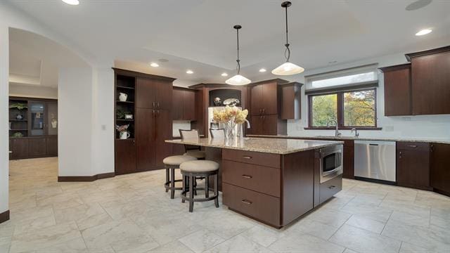 kitchen with a center island, a sink, recessed lighting, and appliances with stainless steel finishes
