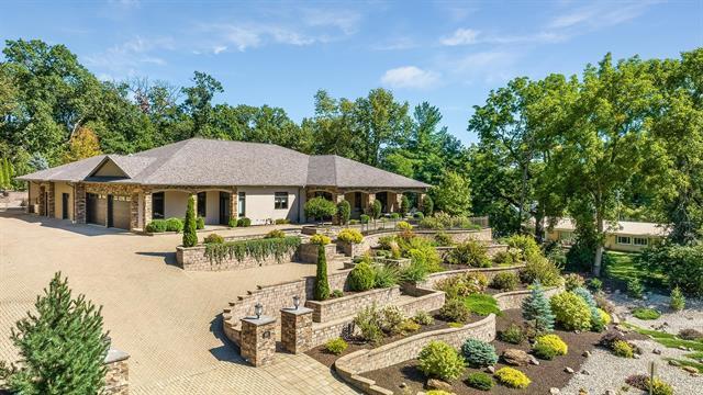 view of property's community featuring a garage and driveway