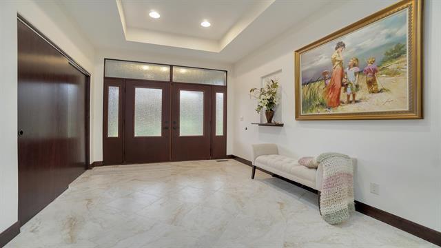 entrance foyer featuring french doors, baseboards, recessed lighting, and a tray ceiling