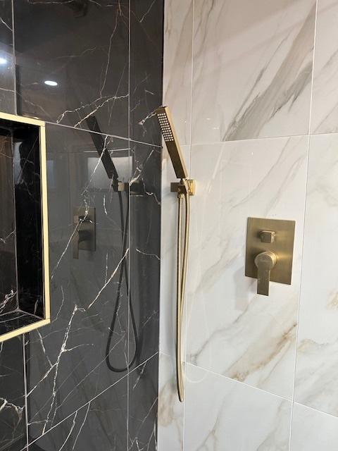 details featuring a marble finish shower