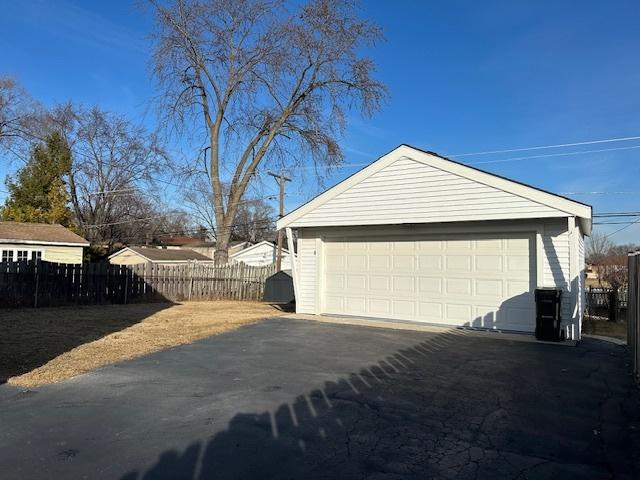 detached garage featuring fence