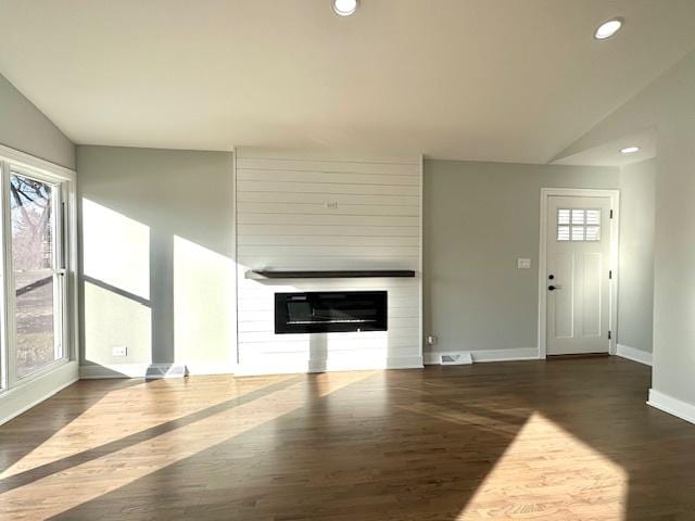 unfurnished living room featuring baseboards, a large fireplace, wood finished floors, and recessed lighting