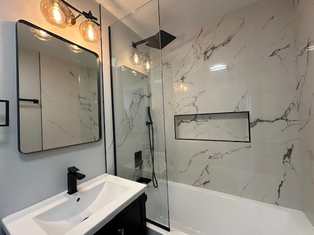 bathroom featuring shower / bathtub combination and vanity