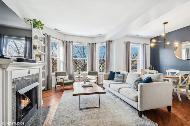 3705 N Paulina St Unit 3, Chicago, IL 60613 - living area with a high end fireplace, wood finished floors, and visible vents