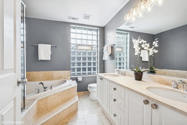 3705 N Paulina St Unit 3, Chicago, IL 60613 - bathroom featuring toilet, visible vents, a sink, and a garden tub