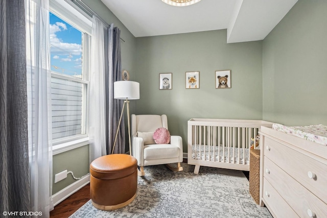 3705 N Paulina St Unit 3, Chicago, IL 60613 - bedroom with a nursery area, baseboards, and wood finished floors