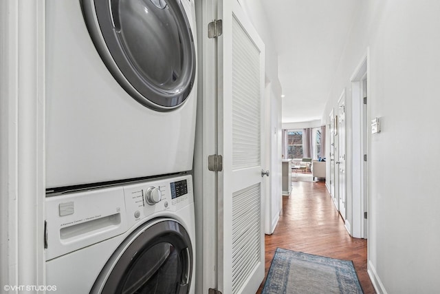 3705 N Paulina St Unit 3, Chicago, IL 60613 - washroom with stacked washer and dryer, laundry area, baseboards, and wood finished floors