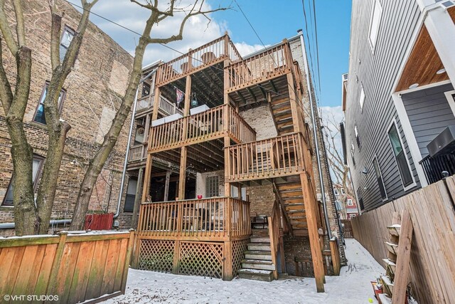 3705 N Paulina St Unit 3, Chicago, IL 60613 - snow covered property featuring fence, a wooden deck, and stairway