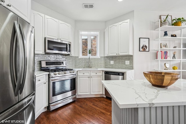 3705 N Paulina St Unit 3, Chicago, IL 60613 - kitchen featuring visible vents, light stone counters, a sink, dark wood finished floors, and stainless steel appliances