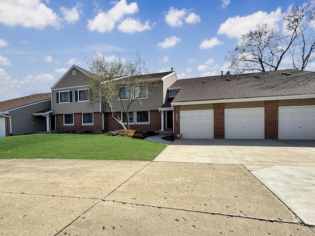 view of front of house featuring a garage, driveway, a front lawn, and brick siding