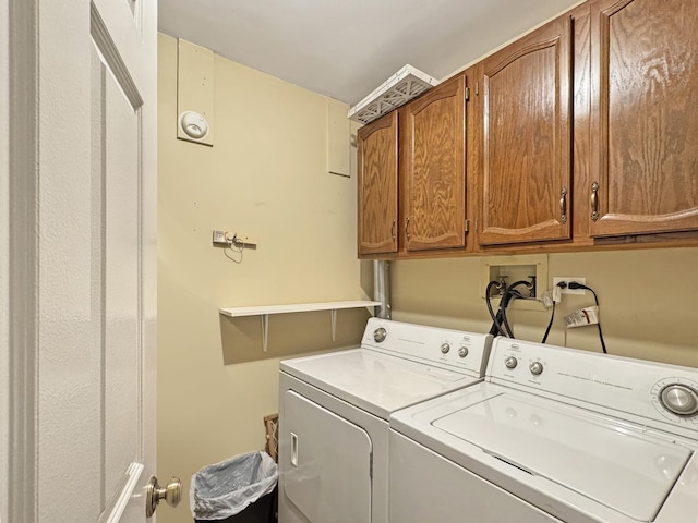 washroom featuring cabinet space and washing machine and dryer