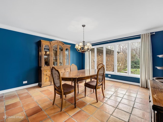 dining area with baseboards, a notable chandelier, and crown molding