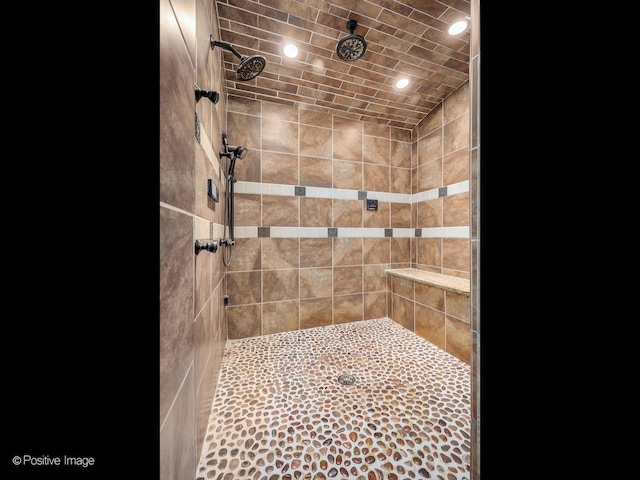 full bathroom featuring recessed lighting and tiled shower
