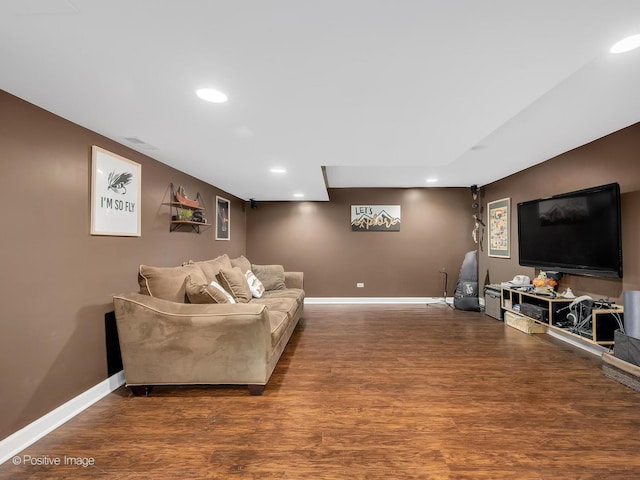 living room featuring visible vents, baseboards, wood finished floors, and recessed lighting