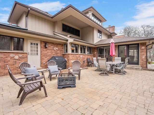 view of patio featuring grilling area, a fire pit, and outdoor dining space