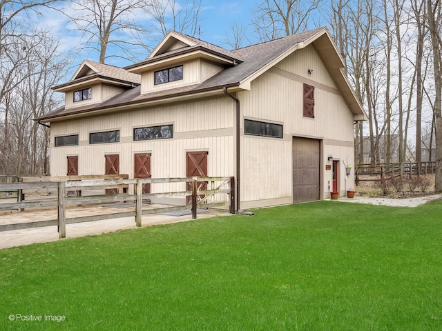exterior space featuring a lawn and fence