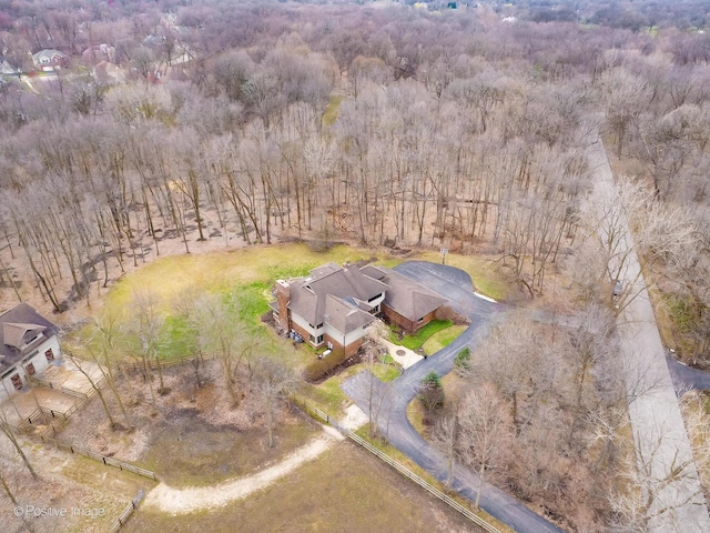 birds eye view of property featuring a view of trees