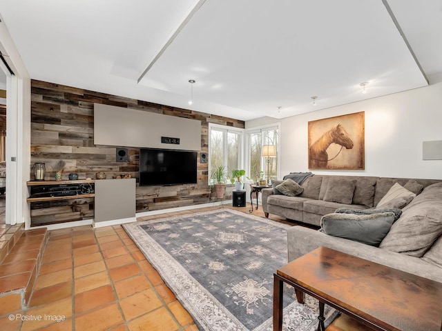 living area with tile patterned floors and wooden walls