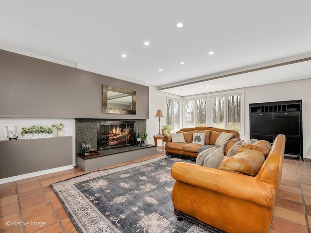 living room with recessed lighting, a premium fireplace, and tile patterned flooring