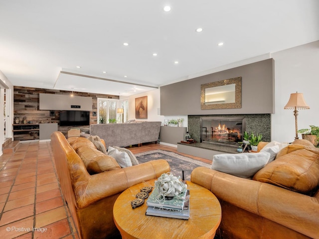 living room with a premium fireplace and recessed lighting