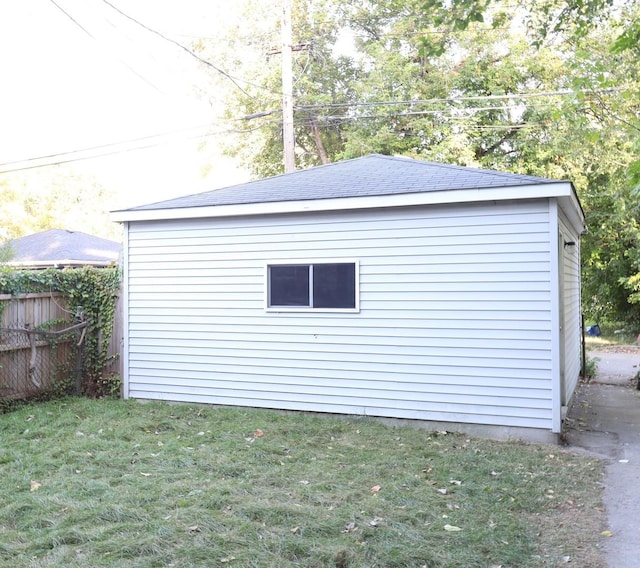 view of outdoor structure featuring an outbuilding and fence