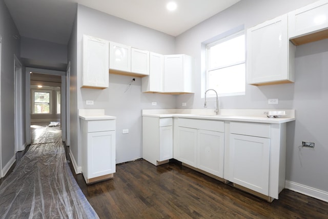 kitchen featuring a sink, white cabinetry, and dark wood-style flooring